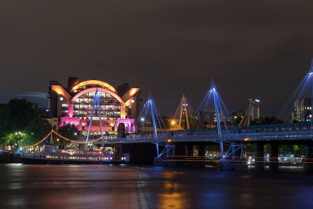 Night photo of the Hungerford and Jubilee bridges in Londonの写真素材