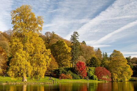 View of the autumn colours around the lake at Stourhead gardens in Wiltshire.の写真素材