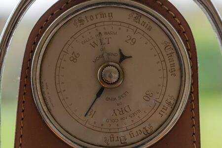 Close up of an old antique barometer made out of an old horses stirrup  indicating high pressure and...