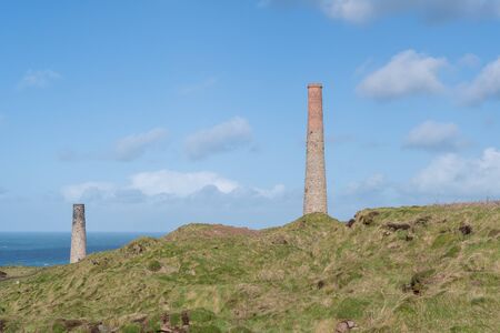Landscape photo of disused industrial chimneys from the mining industry on the Cornish coastの写真素材