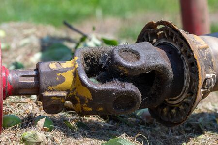 Close up of a PTO shaft with a missing PTO guard on a mower