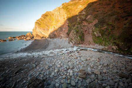 Long exposure of the river Heddon flowing onto the beach at Heddons Mouth in Exmoorの写真素材