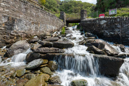 Long exposure of a waterfall flowing onto Lee Abbey Beach in Devonの写真素材