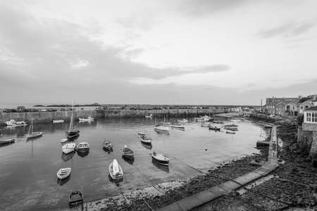 Mousehole.Cornwall.United Kingdom.July 24th 2021.Black and white photo of the fishing village of Mousehole in Cornwall on a summer eveningのeditorial素材