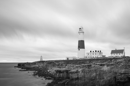 Black and white photo of Portland Bill lighthouse in Dorset at duskの写真素材