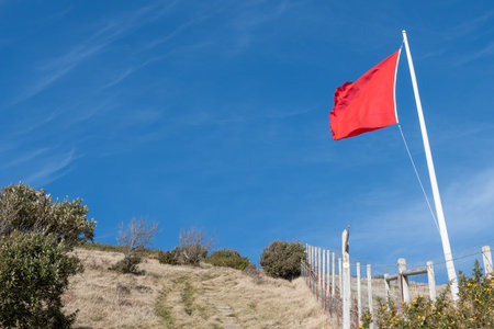 Close up of a red flag blowing in the wind