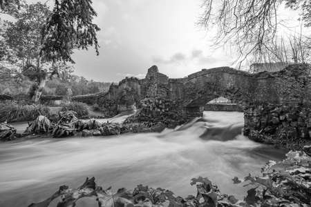 Long exposure of the river Avill flowing under Lovers bridge in the grounds of Dunster castle in Somersetのeditorial素材