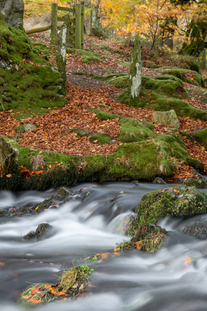 Long exposure of the Weir Water river flowing downstream of Robbers Bridge in Exmoor National Park