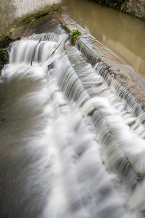 Long exposure of a watefall on the River Lim walkway at Lyme Regis in Dorset.の写真素材