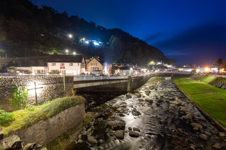 Long exposure of the East and West Lyn river flowing into Lynmouth at nightの写真素材