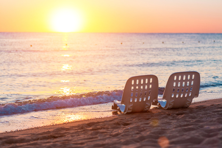 Landscape of Two Lonely beachchairs near sea and beautiful sunrise in the morning at a perfect beach in Egyptの写真素材