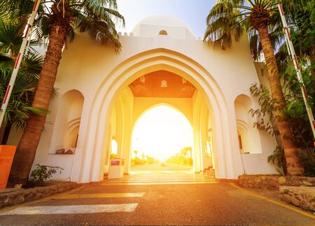 Facade of arch at the entrance beautiful hotel at a tropical holiday resort in Egypt.の写真素材