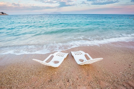 Landscape of Two Lonely beachchairs near the sea in the morning at a perfect beach in Egyptの写真素材