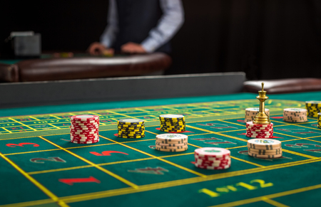 Picture of a green table and betting with chips. Close upの写真素材