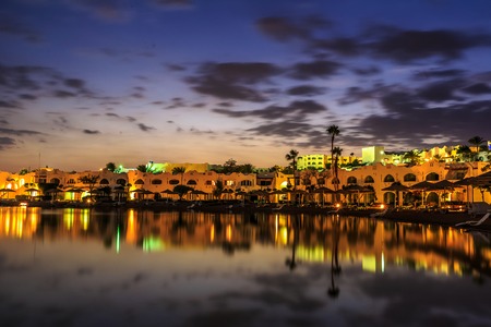 Evening view from sea which reflects the dark sky, for luxury hotel in night illumination on a beautiful resort in Egyptの写真素材