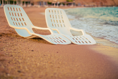 Landscape of Two Lonely beachchairs near the sea in the morning at a perfect beach in Egyptの写真素材