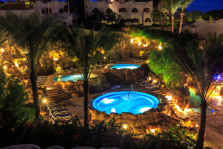 Evening view for luxury swimming pools in night illumination on a beautiful resort in Egyptの写真素材