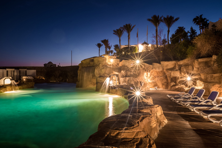 Long exposure shot of a swimming pool at luxury night illumination on a beautiful resort in Egyptの写真素材