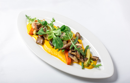 Baked fish King clip with vegetables and sauce, decorated of a greens salad in white plate. Close-upの写真素材
