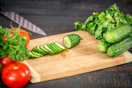 Close up cutting cucumber, making salad. Healthy lifestyle, diet foodの写真素材