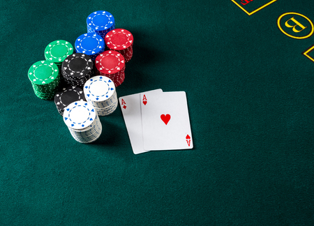 Poker play. Chips and cards on the green tableの写真素材
