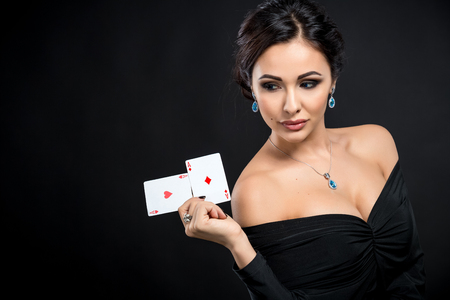 sexy woman with poker cards. Female player in a beautiful black dress.  two acesの写真素材