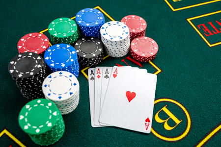 Poker play. Chips and cards on the green table. four acesの写真素材
