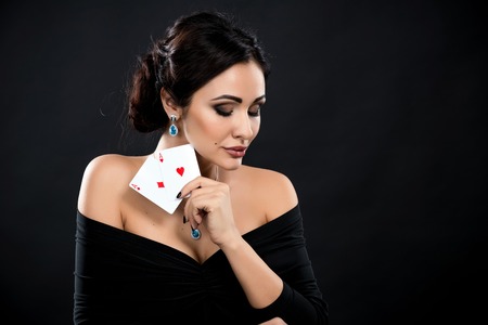 sexy woman with poker cards. Female player in a beautiful black dressの写真素材
