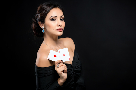 sexy woman with poker cards. Female player in a beautiful black dressの写真素材