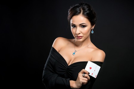 sexy woman with poker cards. Female player in a beautiful black dressの写真素材
