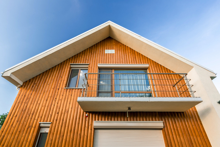 Beautiful wooden house. Facade of traditional homes and sky. at sunset and sunriseの写真素材