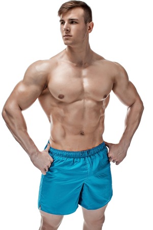 Strong Athletic Man showing muscular body and sixpack abs isolated on white backgroundの写真素材