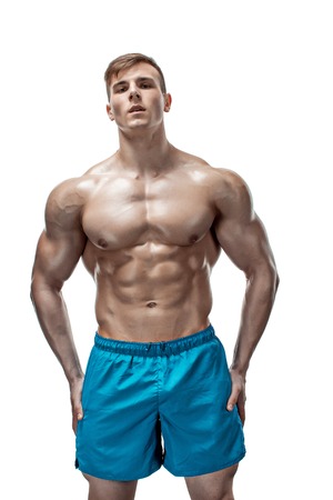 Strong Athletic Man showing muscular body and sixpack abs isolated on white backgroundの写真素材