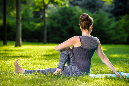 Young fitness woman meditation in a city park.Yoga at sunset in the park. Girl is practicing yoga. Fitness training outdoors. Attractive fitness woman. Workout outdoors. Healthy lifestyleの写真素材