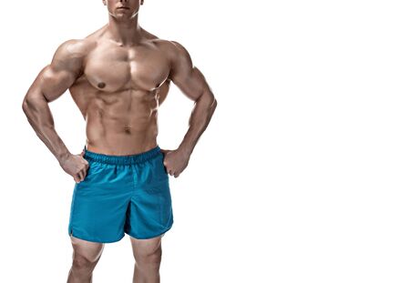Strong Athletic Man showing muscular body and sixpack abs isolated white background. Close up, copyspaceの写真素材