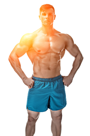Strong Athletic Man showing muscular body and sixpack abs isolated white background. with sun flareの写真素材