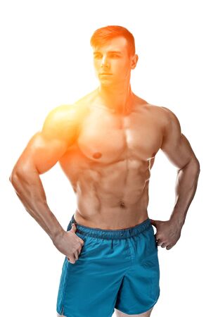 Strong Athletic Man showing muscular body and sixpack abs isolated on white background. with sun flareの写真素材