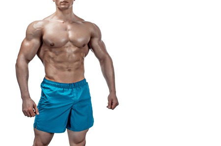 Strong Athletic Man showing muscular body and sixpack abs isolated on white background. Close up, copyspaceの写真素材