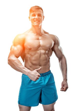 Strong Athletic Man showing muscular body and sixpack abs isolated on white background. with sun flareの写真素材