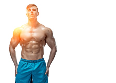 Strong Athletic Man showing muscular body and sixpack abs isolated on white background. with sun flare. copyspaceの写真素材