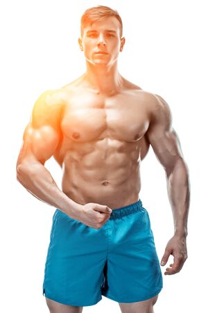 Strong Athletic Man showing muscular body and sixpack abs isolated on white background. with sun flareの写真素材