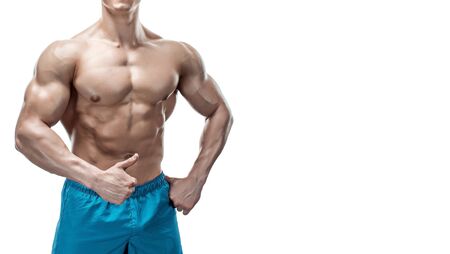 Strong Athletic Man showing muscular body and sixpack abs isolated on white background. Close up, copyspaceの写真素材