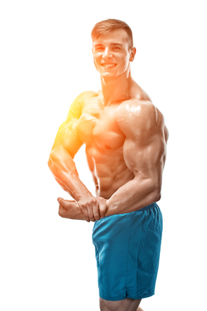 Strong Athletic Man showing muscular body and sixpack abs isolated on white background. with sun flareの写真素材