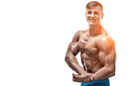 Strong Athletic Man showing muscular body and sixpack abs isolated on white background. with sun flare. Close up, copyspaceの写真素材