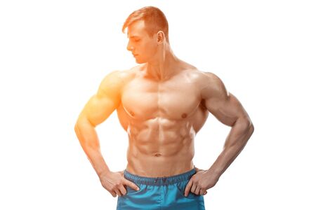 Strong Athletic Man showing muscular body and sixpack abs isolated on white background. with sun flareの写真素材