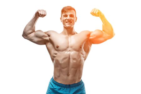 Strong Athletic Man showing muscular body and sixpack abs isolated on white background. with sun flareの写真素材