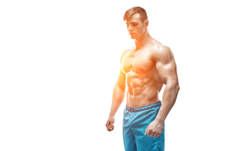 Strong Athletic Man showing muscular body and sixpack abs isolated on white background. with sun flareの写真素材