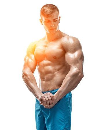 Strong Athletic Man showing muscular body and sixpack abs isolated white background. with sun flareの写真素材