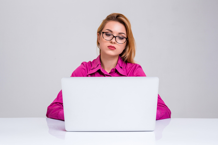 Young businesswoman working at laptop computer. she was tired and looking at monitorの写真素材