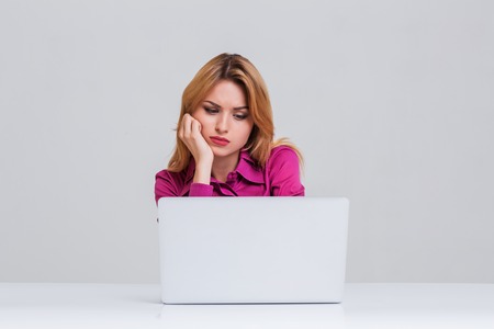 Young businesswoman working at laptop computer. she was tired and looking at monitorの写真素材